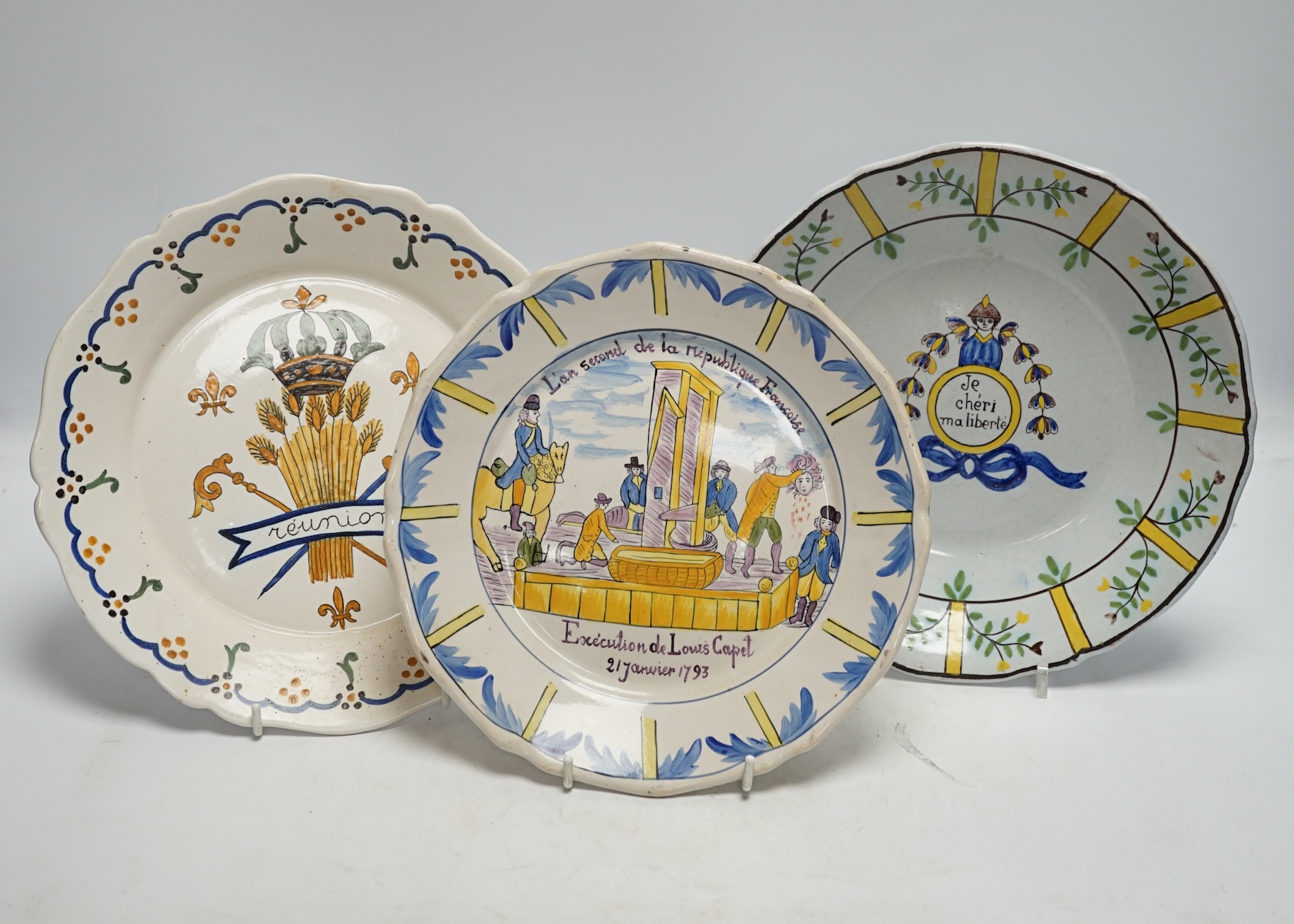 A collection of twenty 18th/19th century French faience polychrome and blue and white Revolution commemorative plates and three others, largest 27cm diameter (23). Condition - condition varies poor to good